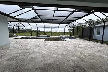 Large pool enclosure with travertine deck